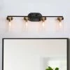 29 in. Modern 4-Light Black and Brass Gold Bathroom Vanity Light, Clear Glass Shade Bath Lighting Cylinder Wall Sconce by Zevni